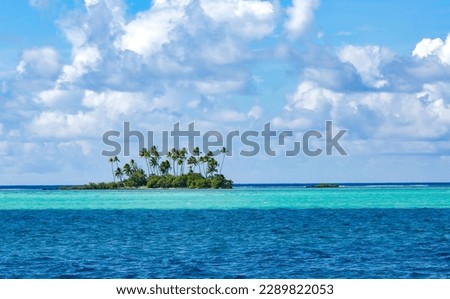Beautiful unoccupied Paradise island in the blue lagoon on the Leeward group of the Society Islands of French Polynesia. Royalty-Free Stock Photo #2289822053