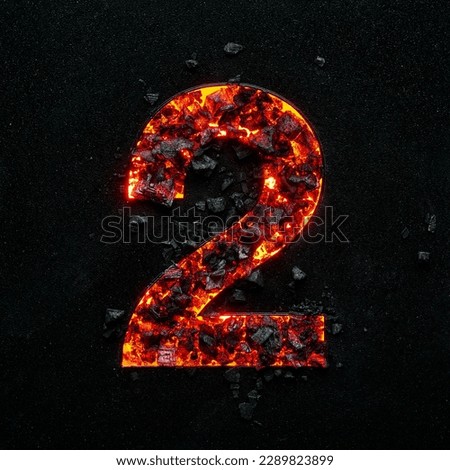 Photo of the burning number tow on a black background made of hot coals.