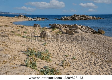The sandy beach of San Giovanni with granitic rocks. The rocky coast of beach San Giovanni in the south-west of Corsica, France