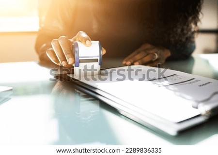 African American Black Woman Using Notary Stamp On Official Paper Royalty-Free Stock Photo #2289836335