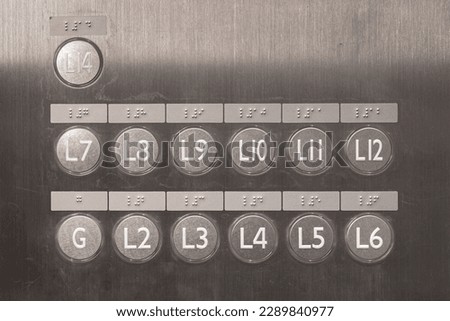 An elevator level button panel with braille code and 3d spot for blindness person. Sign and symbol in transportation system object photo.