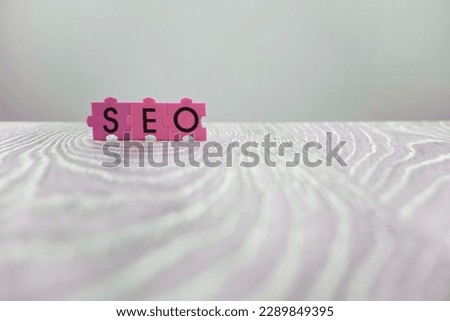 Closeup shot of seo word on gray wooden background 