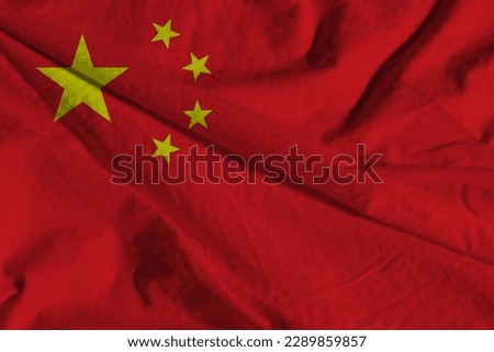 Flag of the Peoples Republic of China or Five-Starred Red Flag representing the Communist Party in a close up full frame textured view