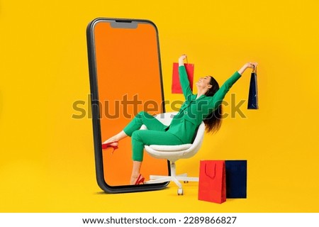 Excited female shopaholic sitting on chair with shopper bags near giant cellphone display over yellow studio background. Cheerful woman enjoying seasonal sales. Collage Royalty-Free Stock Photo #2289866827