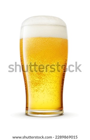Tulip pint glass of fresh frothy yellow beer with cap of foam isolated on white background. Royalty-Free Stock Photo #2289869015