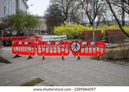 Plastic portable barrier or hazardous area barrier for pedestrians and service personnel. Pedestrian access was closed during construction work.