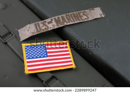 U.S. Marines Branch Tape with national US flag patch on green ammo can background