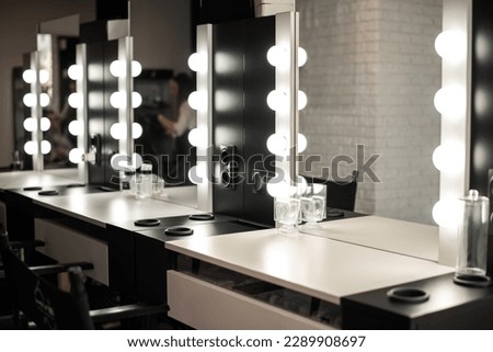 Blurred background of a beauty salon, a make-up table with lighting, cinema lights, interior of a hairdressing salon Royalty-Free Stock Photo #2289908697