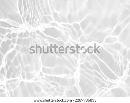 Defocus blurred transparent white colored clear calm water surface texture with splashes and bubbles. Trendy abstract nature background. Water waves in sunlight with copy space. White water shine Royalty-Free Stock Photo #2289936833