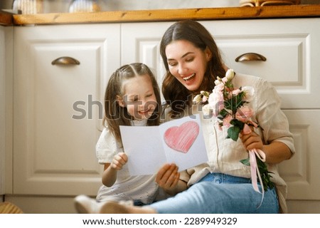 Happy mother's day. Child daughter congratulating her mother and giving her bouquet of flowers. Royalty-Free Stock Photo #2289949329