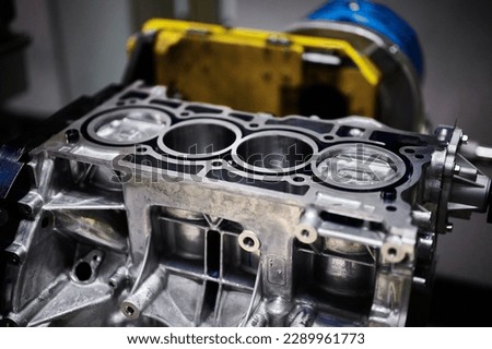 Engine cylinder block with installed pistons in workshop Royalty-Free Stock Photo #2289961773