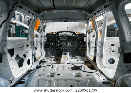 New empty automobile body in facrory assembling workshop Royalty-Free Stock Photo #2289961799