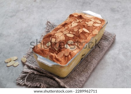 Klappertaart is one of indonesian traditional dessert, from Manado. Bread klappertaart with raisin and almond topping, dusted with cinnamon powder, Dutch influenced dessert. Royalty-Free Stock Photo #2289962711