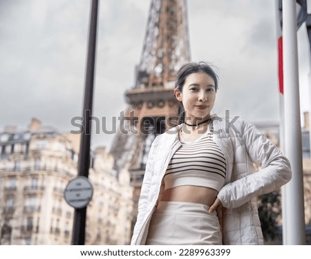 Women walking in Paris streets with Eiffel tower background.