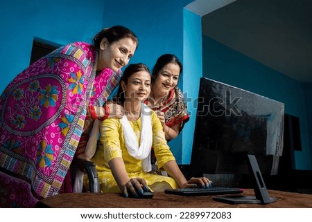 Rural indian women using and learning computer. Young girl teaching and educating married woman use of technology at village. Skil india. Royalty-Free Stock Photo #2289972083