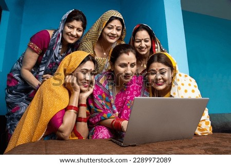 Group of young traditional indian women wearing sari learn to use laptop or computer. Technology in rural household. Concept of education and women empowerment. Royalty-Free Stock Photo #2289972089
