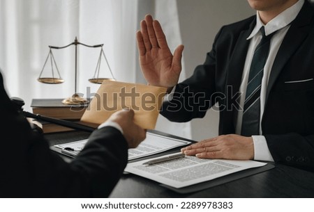 Businessman or accountant is rejecting and resisting partner bribery deals in joint financial settlement, illegal anti-bribery ideas. In work Royalty-Free Stock Photo #2289978383