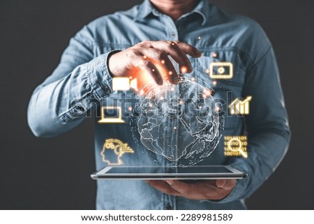 Man holding tablet and world diagram with icons, Marketers education, research, analyze media video streaming content creation and online marketing strategies to grow their digital business. Royalty-Free Stock Photo #2289981589