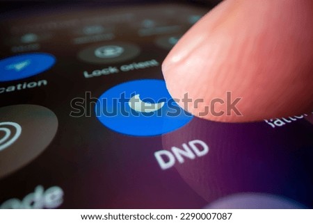 Macro shot of switching smartphone to do not disturb mode Royalty-Free Stock Photo #2290007087
