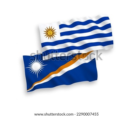 National vector fabric wave flags of Oriental Republic of Uruguay and Republic of the Marshall Islands isolated on white background. 1 to 2 proportion.