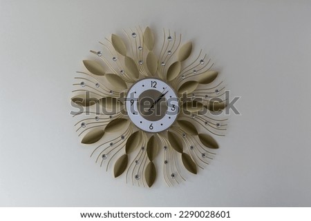 Modern wall clock. Beautiful metal clock on the wall inside the apartment. Selective focus