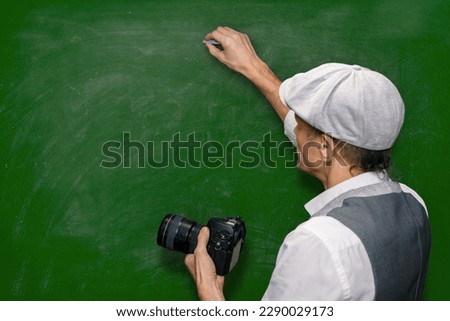 Male teacher explaining different shooting techniques during lesson in photo school