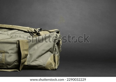 Army bag on dark grey background, space for text. Military equipment