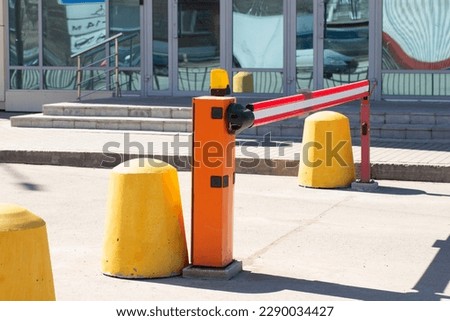 A barrier for automatic gates.Parking for cars.