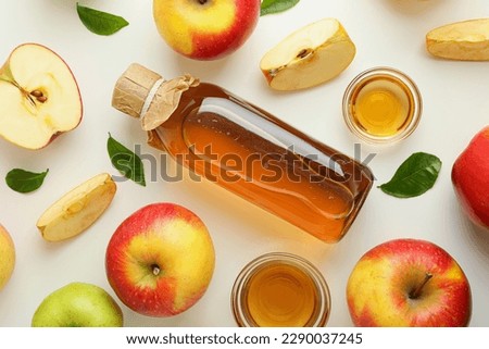 Homemade apple vinegar and ingredients on white background Royalty-Free Stock Photo #2290037245