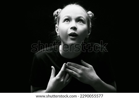 Black-and-white shot of a beautiful girl who is in her thoughts. Psychological picture. Children, emotions.