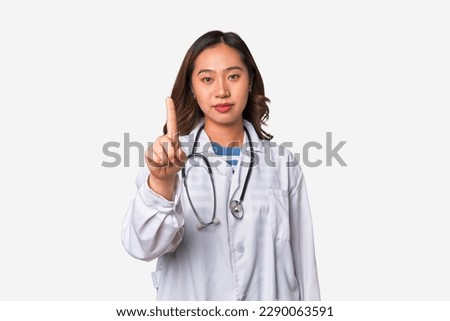 A young asian doctor woman showing number one with finger.