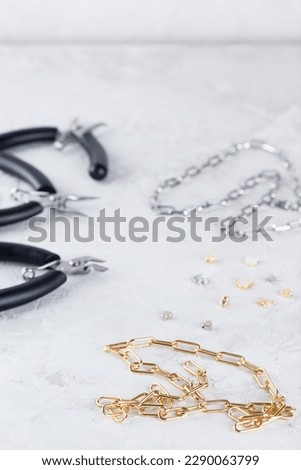 Making jewelry bijouterie, accessories for chains and necklaces. Handmade jewelry, small business, hobby concept. Vertical orientation. Royalty-Free Stock Photo #2290063799
