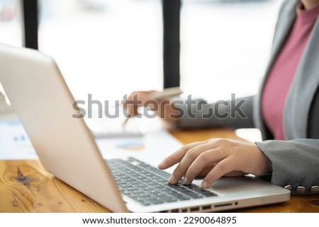 Business Woman working by using laptop computer Hands typing on a keyboard. Professional investor working new start up project. business planning in office. Technology business Concept. 
