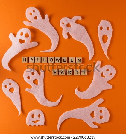 White ghosts craft for Halloween party. Wrapping paper ghost on orange background top view. Cartoon creepy Whisper. DIY hand made. Set boo characters. Word wooden letter phrase.