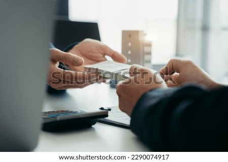 Government officials receiving bribe money from business man the concept of corruption and anti bribery. Royalty-Free Stock Photo #2290074917