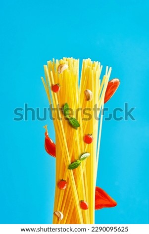Concept of Italian spaghetti pasta with tomatoes, basil, garlic and red sauce. Pasta cooking poster. Creative picture pasta ingredients