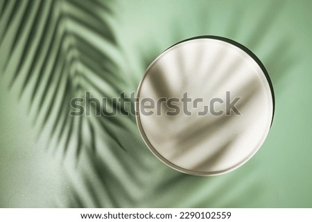Top view of white podium with leaves and shadows. Realistic platform for product presentation. Minimal nature scene with pedestal mockup. cosmetic display or award ceremony Royalty-Free Stock Photo #2290102559