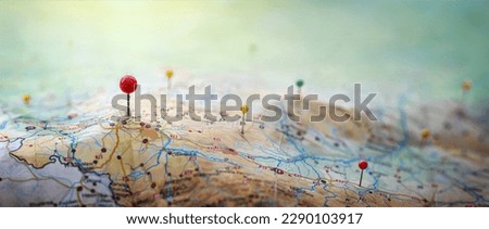 Pins on a geographic map curved like mountains. Pinning a location on a map with mountains. Adventure, discovery, navigation, geography, mountaineering, hike  and travel concept background. Royalty-Free Stock Photo #2290103917