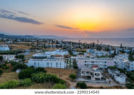 Sunset drone aerial photography - Crete, Greece - city lanscape with sea in the background