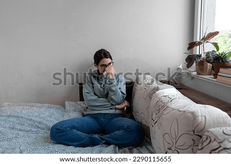 Ill upset young woman sitting on sofa covered with blanket freezing blowing running nose got fever caught cold sneezing in tissue, sick girl having influenza symptoms coughing at home, flu concept Royalty-Free Stock Photo #2290115655