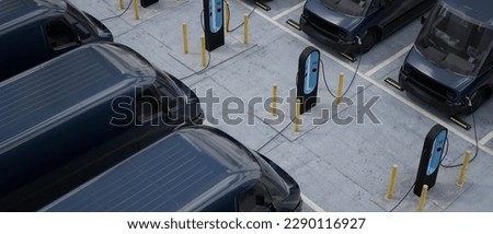 Overhead shot of electric EV delivery vans are being charged in company parking garage Royalty-Free Stock Photo #2290116927