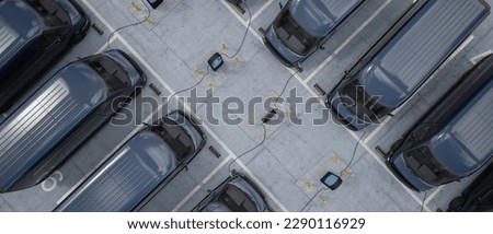 Overhead shot of electric EV delivery vans are being charged in company parking garage Royalty-Free Stock Photo #2290116929