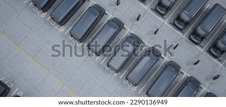 Overhead shot of electric EV delivery vans are being charged in company parking garage Royalty-Free Stock Photo #2290136949