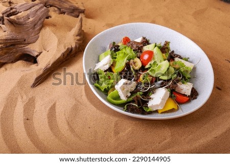 Picture of a Greek salad in the sand