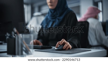 Close Up of a Middle Eastern Engineer Working on Computer in a Technological Corporate Office. Young Muslim Woman Writing Software Code for an Innovative Internet and Software as a Service Project