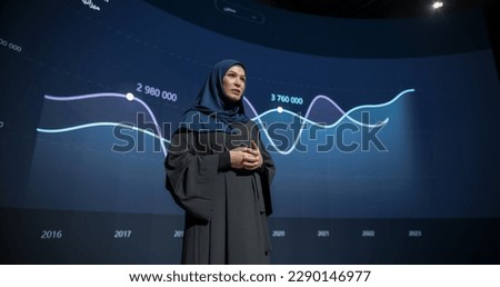 Saudi Businesswoman Making a Presentation on Stage During a Middle Eastern Business Conference. Entrepreneur in Hijab Talking About Financial Growth, New Market Development, Marketing Strategy Royalty-Free Stock Photo #2290146977