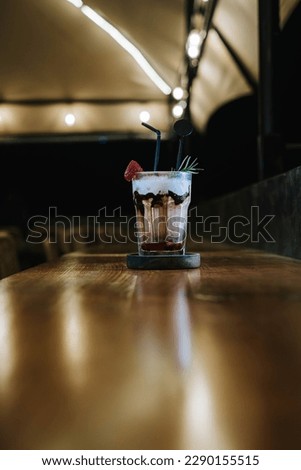 Portrait or vertical shot of a glass of Strawberry Juice Frappe with blurred background