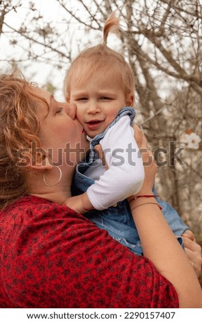 a mother kisses her daughter 