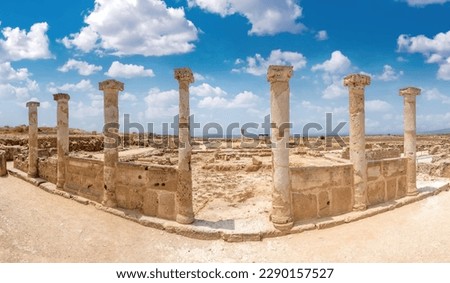 Cyprus panorama. Paphos necropolis. Surviving columns in archaeological park tombs of kings in city of Paphos. Necropolis in republic of Cyprus. Trip to country of Cyprus. Mediterranean attractions Royalty-Free Stock Photo #2290157527