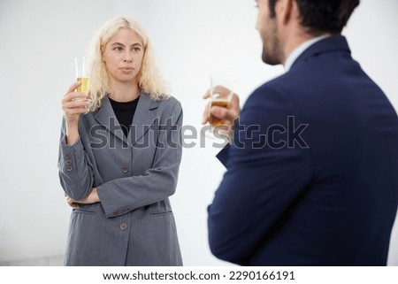 businesswoman talking with businessman and holding a glasses of beer in the office